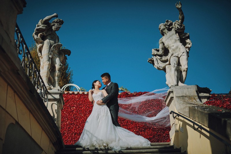 Bridge & Groom at the Vrtba Garden as her veil blows