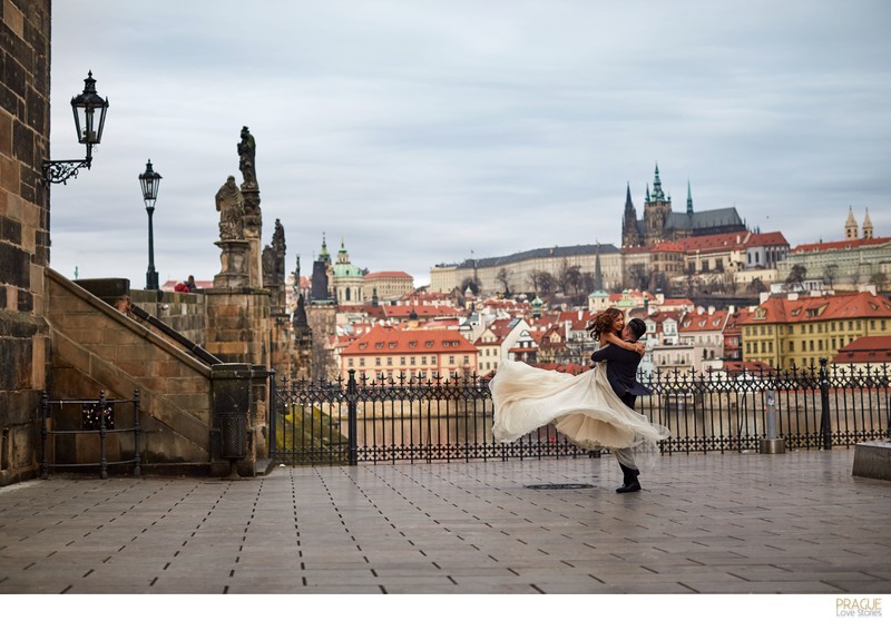 spinning his bride near the Charles Bridge