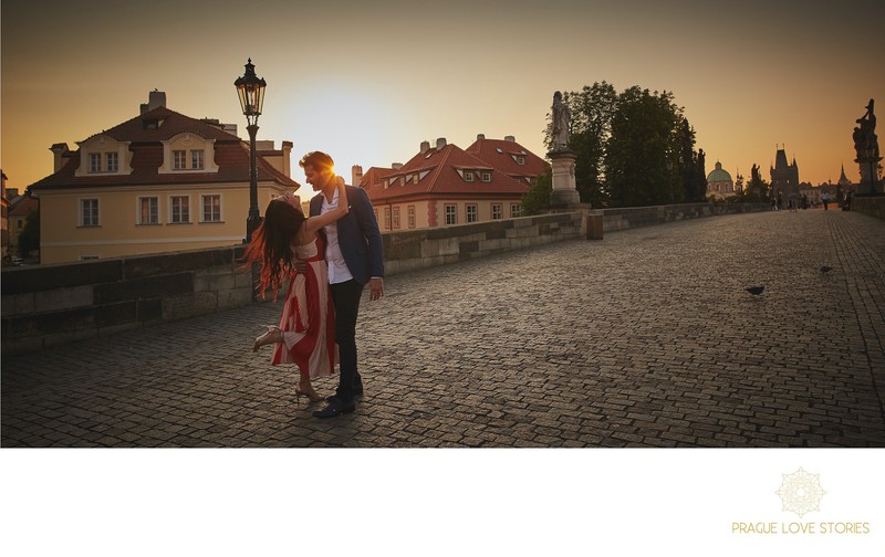 sharing a moment on the Charles Bridge at sunrise