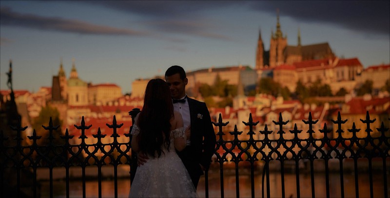 Silhouetted against the Prague skyline at sunrise