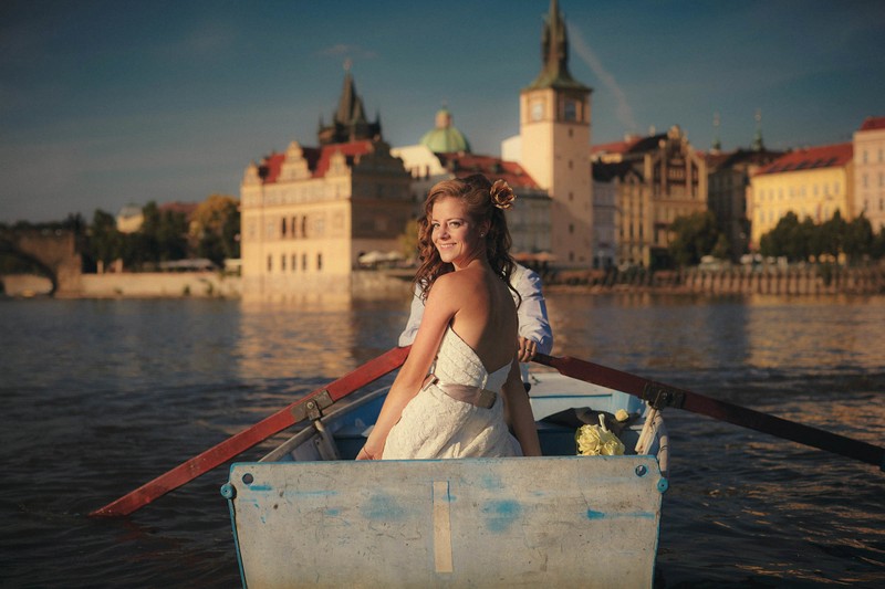 Beautiful bride & groom in rowboat in Prague