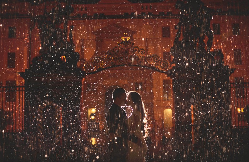 A sexy kiss in the torrentail rain at Prague Castle