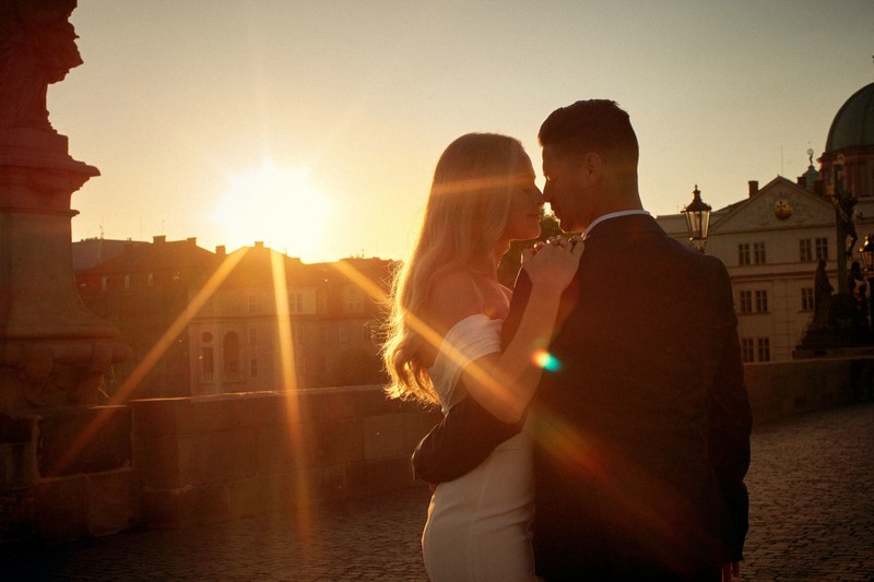 Sun flared Love Story atop Charles Bridge Prague