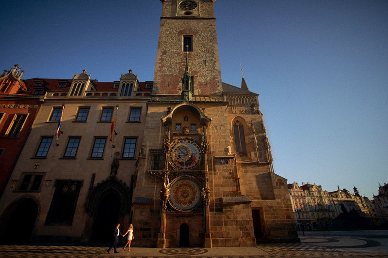 American couple bathed in the Golden Light under the Astronomical Clock