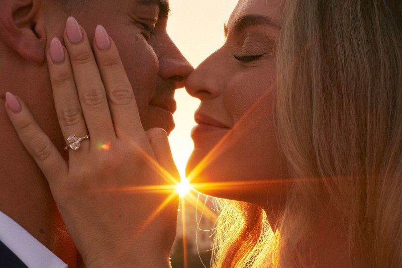 Intimate Kiss As The Sun Flares Vividly Around Them In Prague