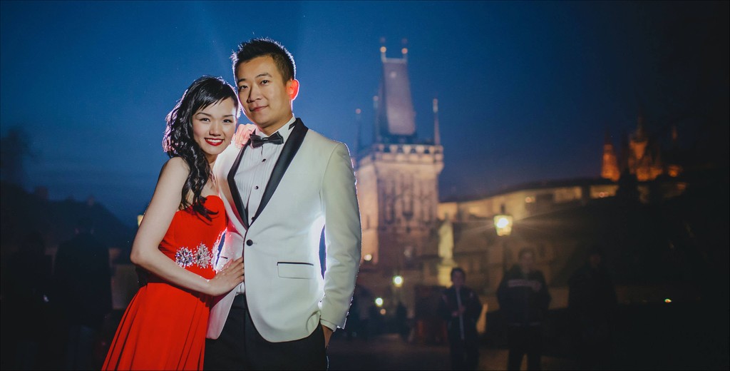 Elegant Hong Kong couple atop Charles Bridge at night