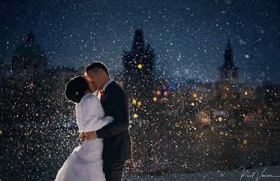 winter kiss in snow Prague weddings Charles Bridge