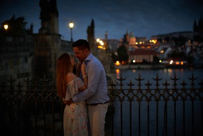 sexy couple embrace Prague Charles Bridge at night