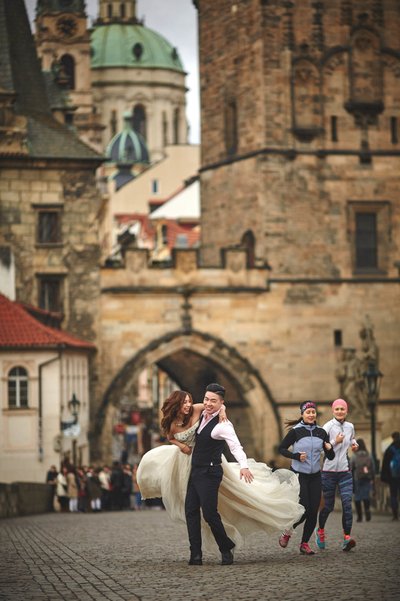 Spinning his bride atop the Charles Bridge