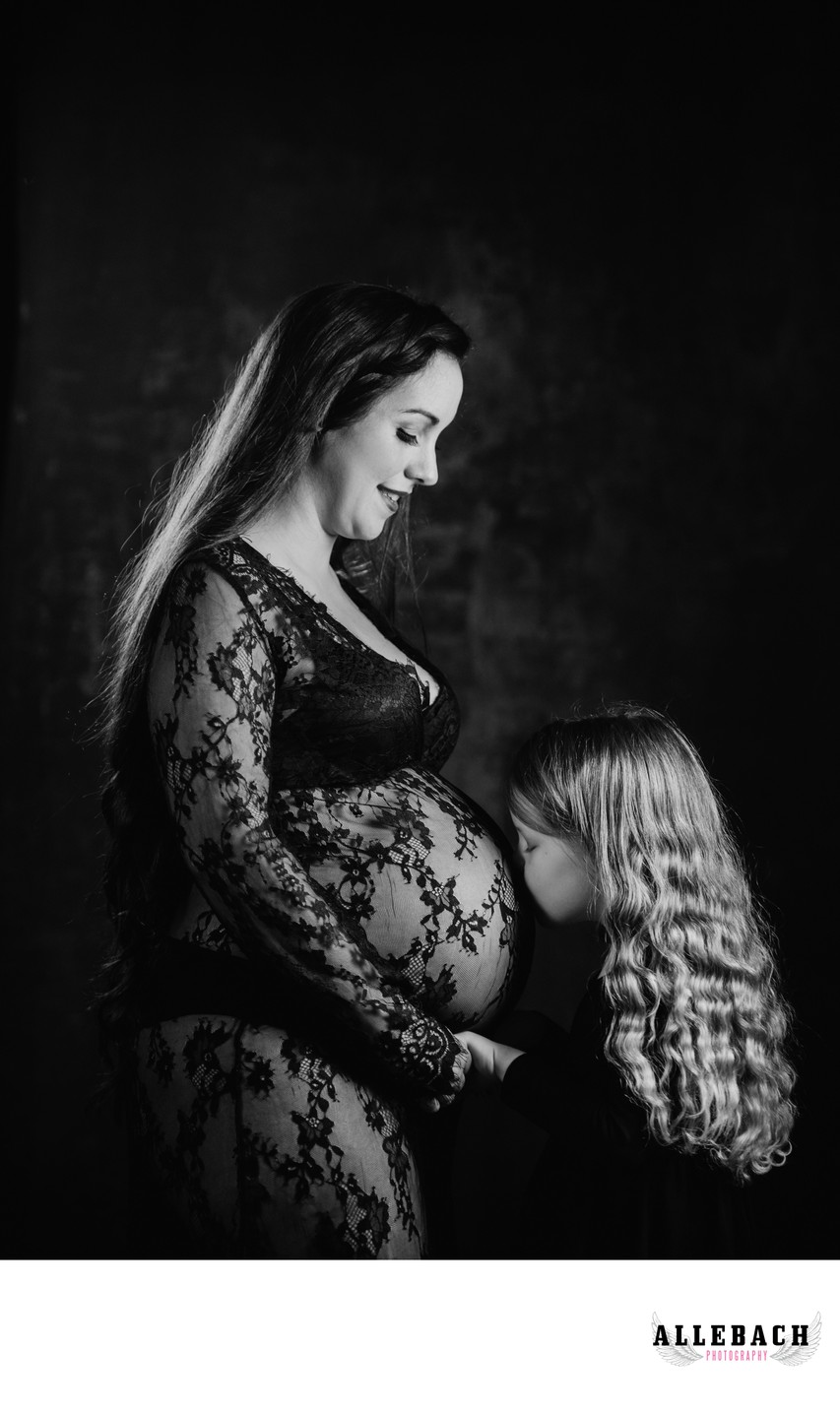 Daughter Kissing Pregnant Mother During Maternity Photos