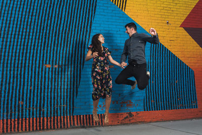 Couple Jumping in DUMBO Engagement photo Session