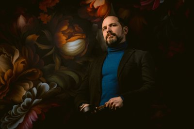 Man's Portrait on Flower Wall in Studio at Allebach Photography