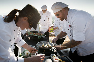Chefs prepare dinner outdoors at biodynamic farm
