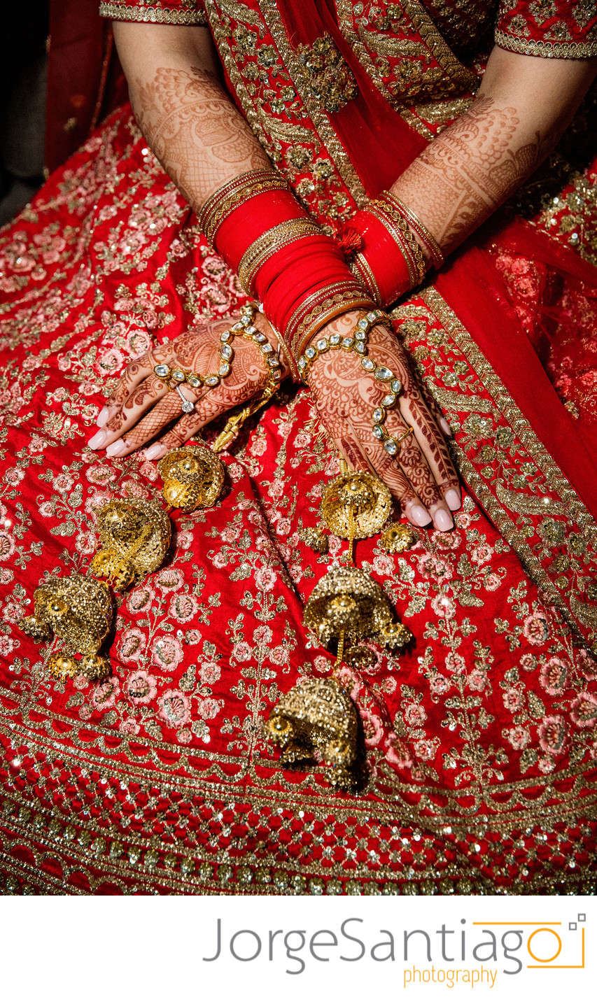 close up of south asian brides henna and bangle addorned hands 